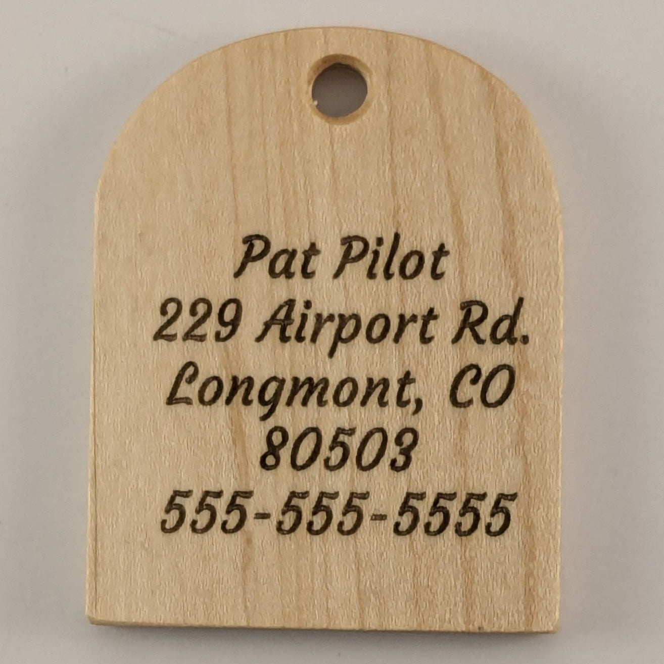 Wooden tag with engraved address and phone number on Poplar
