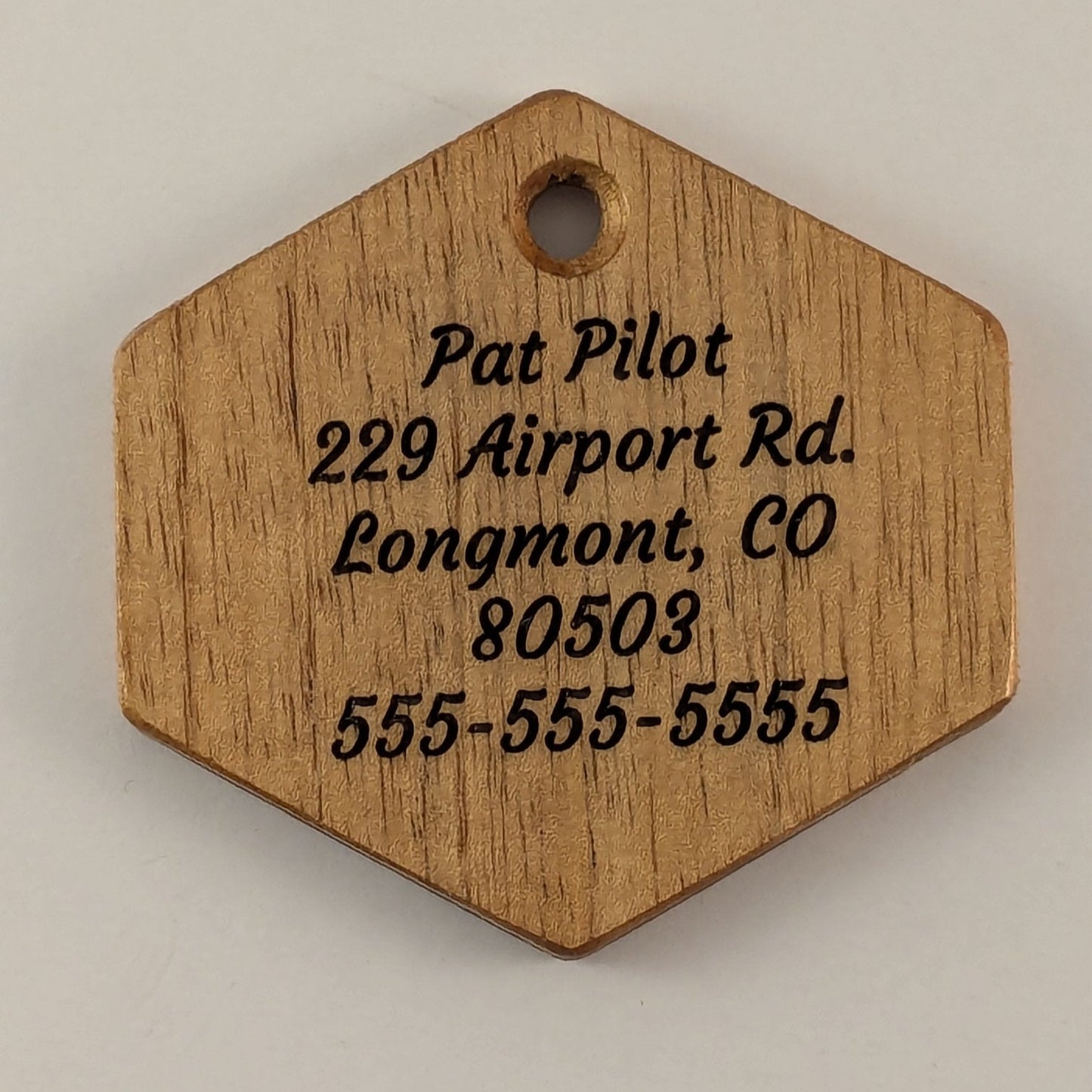 Wooden hexagonal tag with engraved text on Spanish Cedar