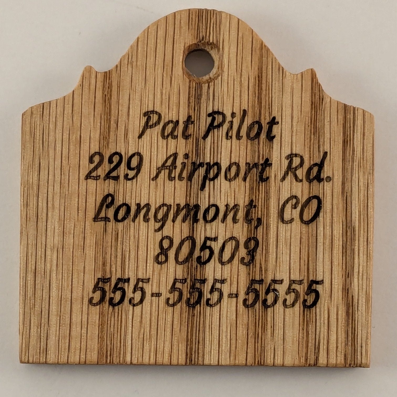 Wooden sign with engraved text on Oak